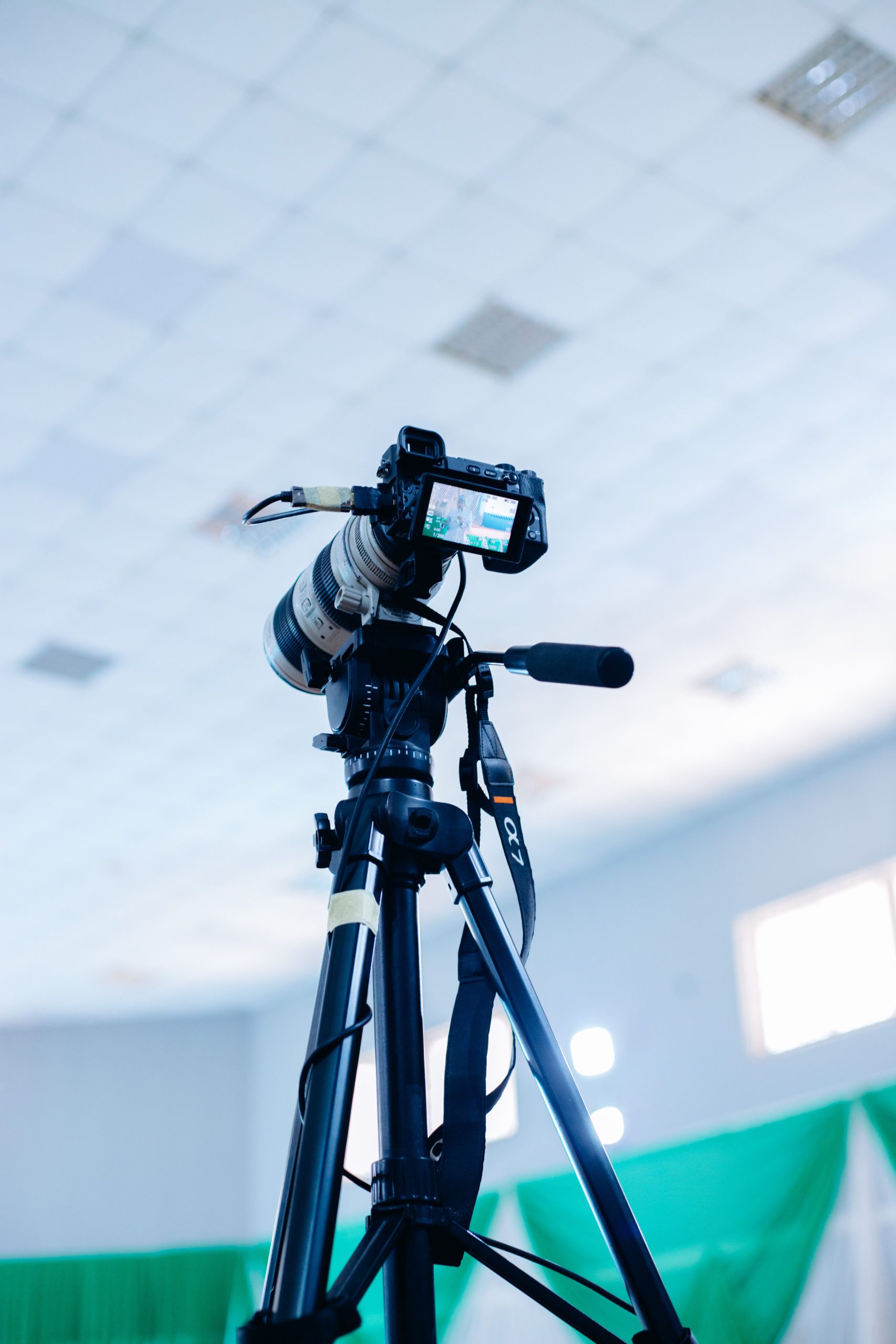 High-quality DSLR camera mounted on a tripod in an indoor studio setting.